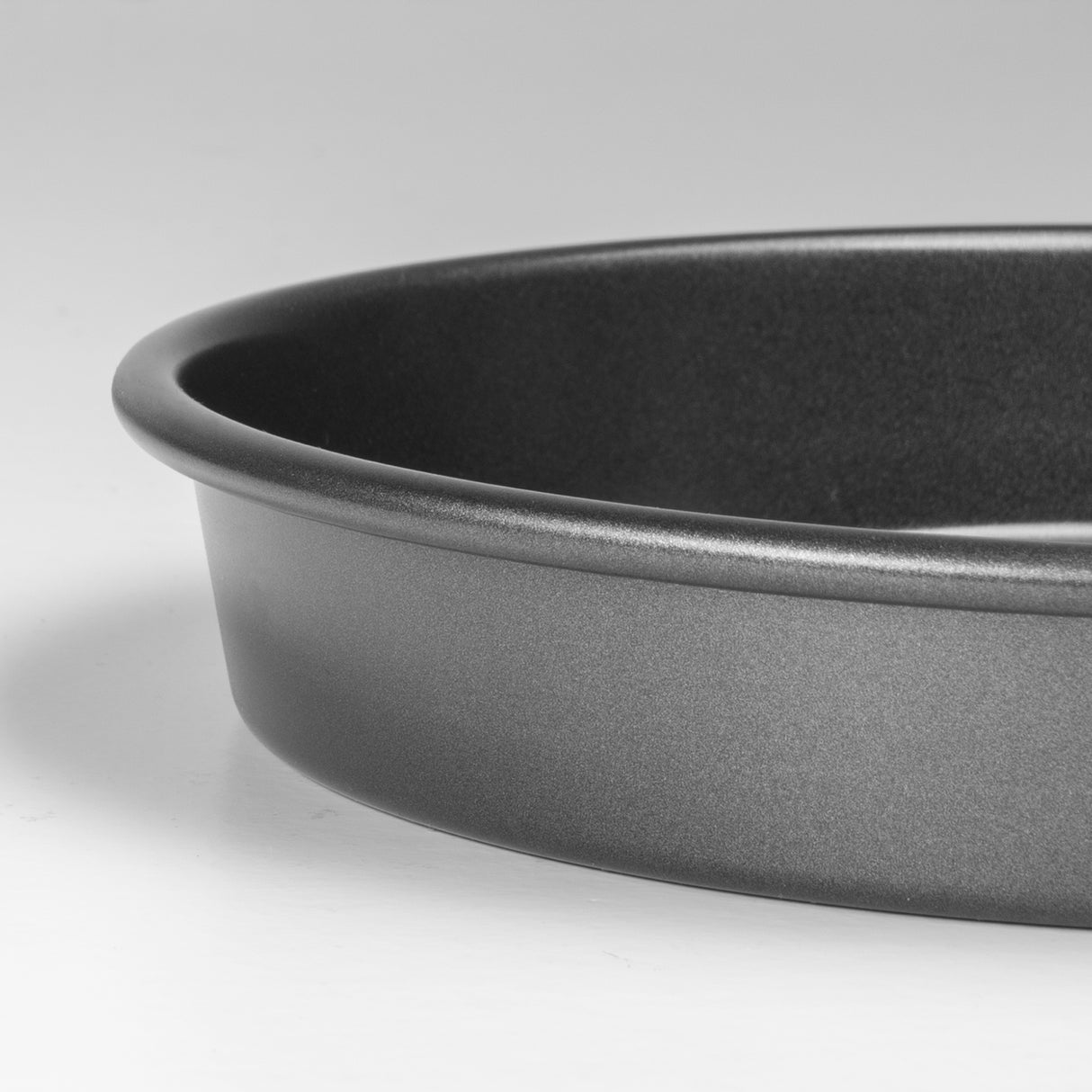 Close-up of a grey baking dish on a light grey background