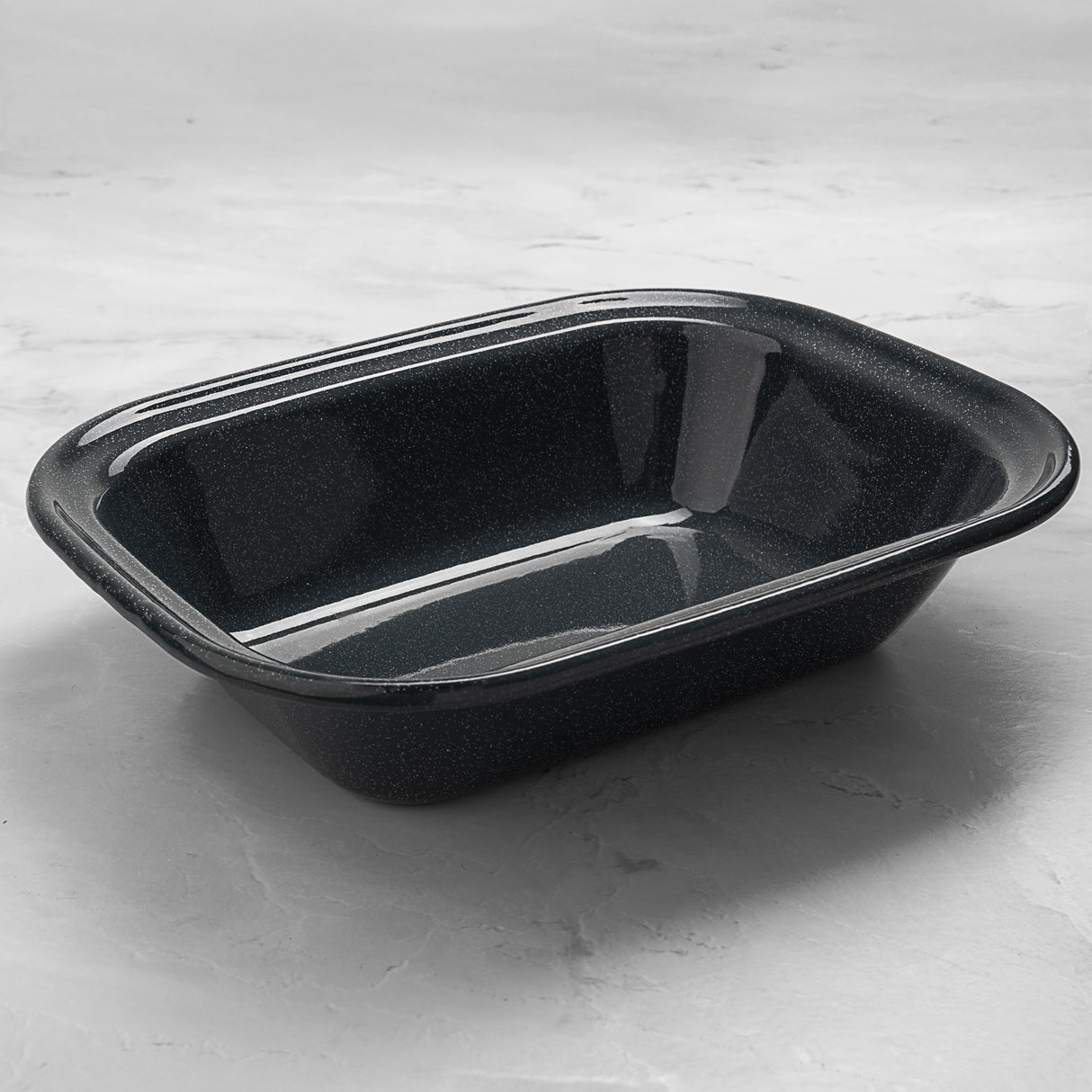 Grey enamel rectangular pie dish on a light grey surface