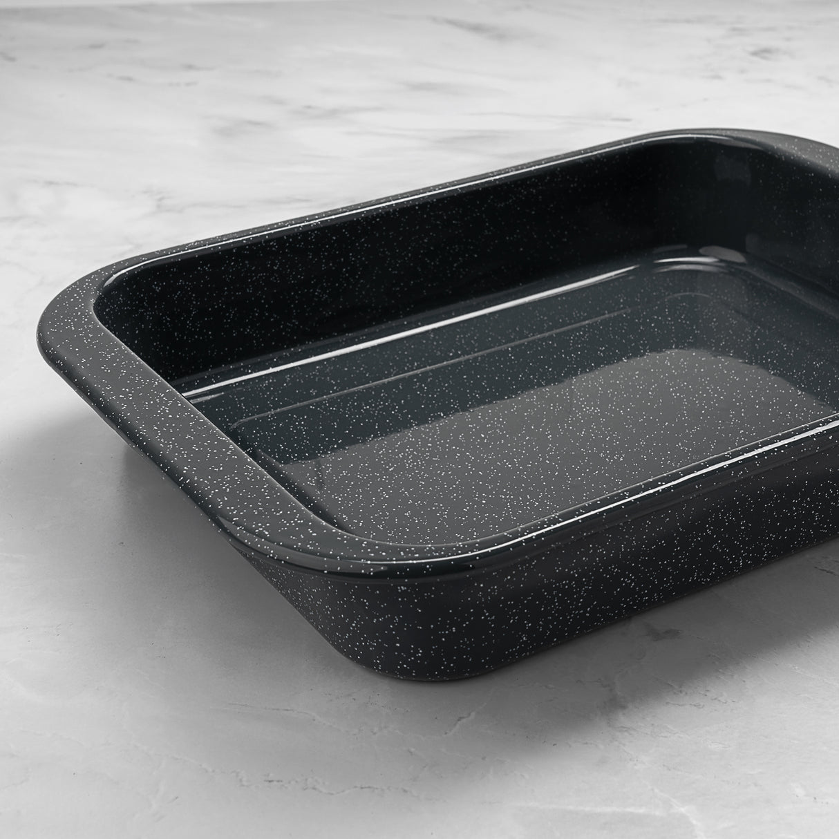 Grey speckled roasting tray on a light grey surface