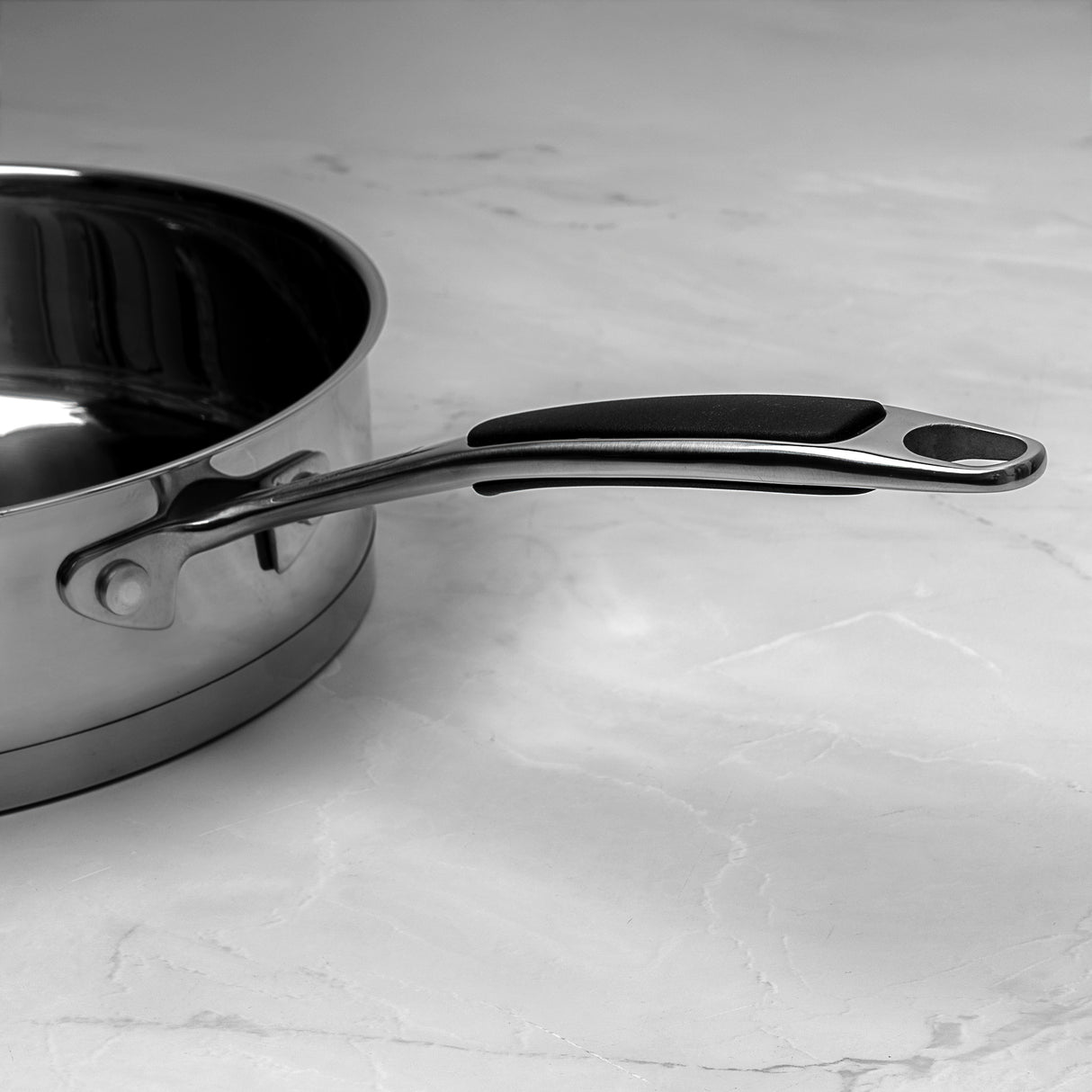 Stainless steel saute pan on a marble countertop