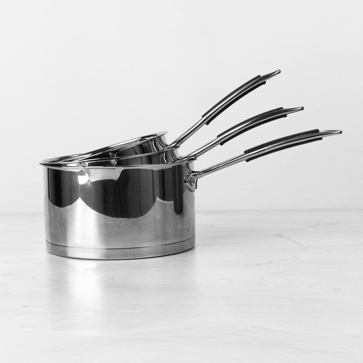 Set of three ProChef stainless steel pots on a white background
