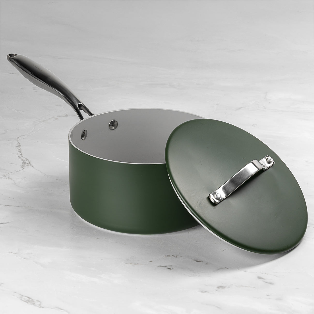 Green pot with lid on a marble surface