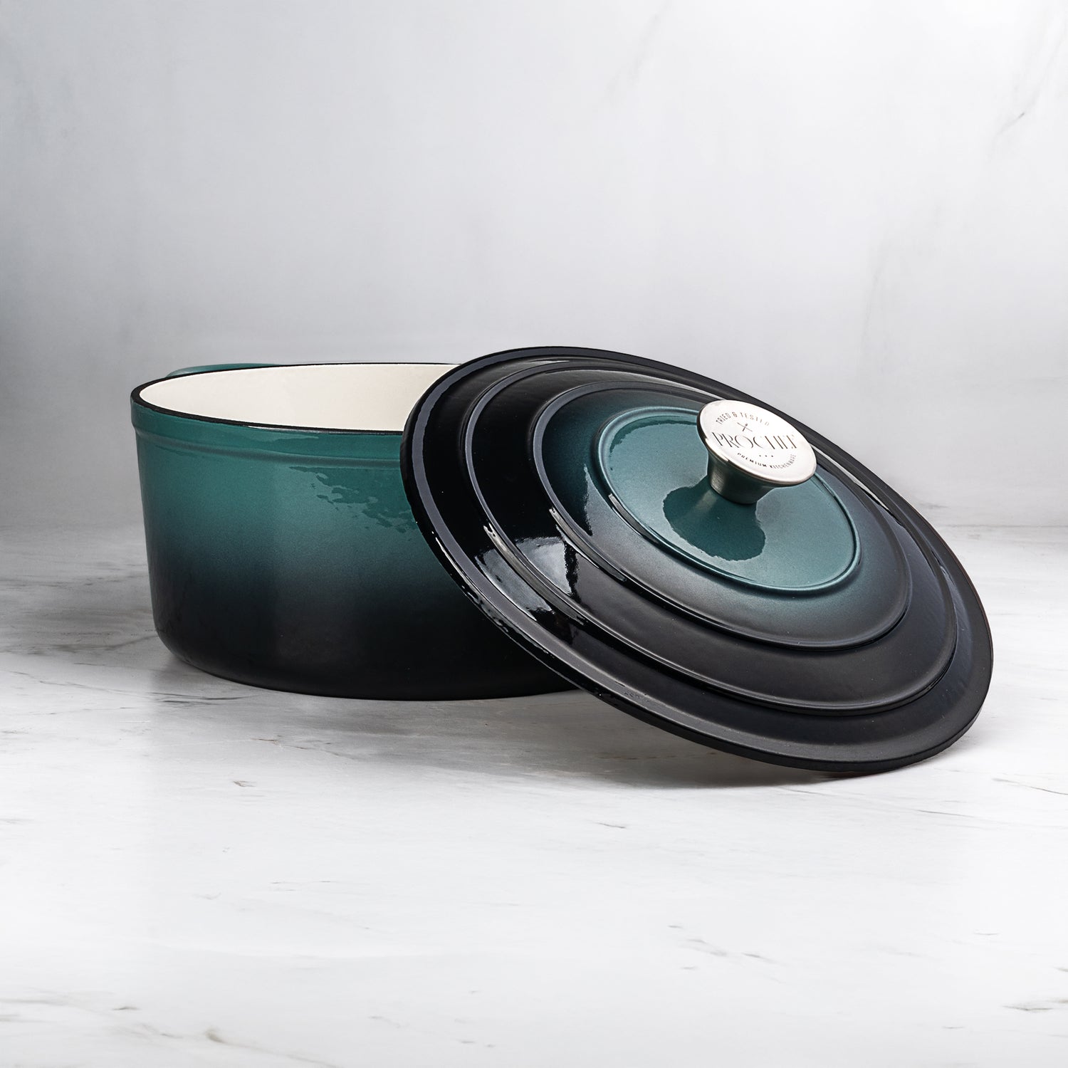 ProChef round cast iron casserole dish in deep teal with matching lid, enamel interior, perfect for slow cooking and roasting.