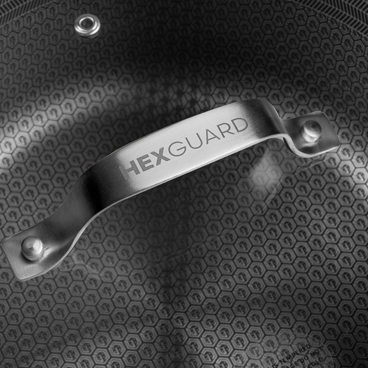 HexGuard pan lid on a pan with the textured cooking surface showing through the glass