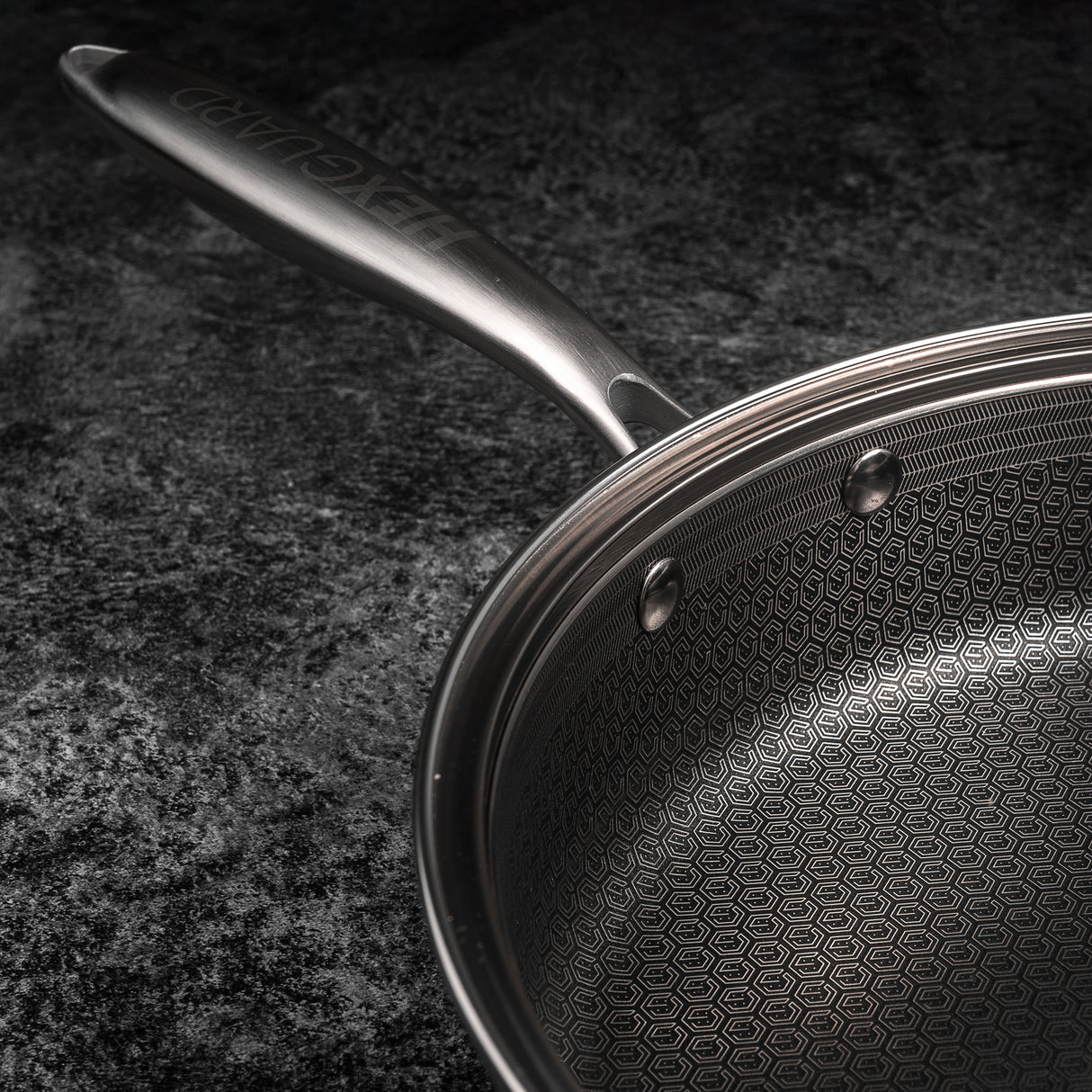 Close-up of a frying pan with a textured surface on a dark background