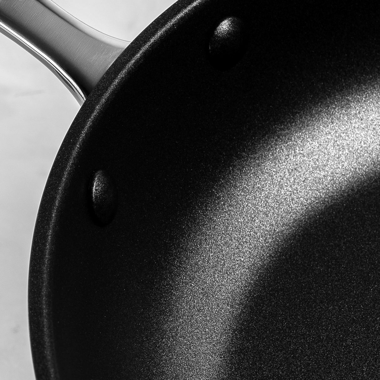 Close-up of ProChef non-stick frying pan interior, showing textured black cooking surface with stainless steel riveted handle.