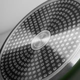 Close-up of ProChef frying pan base with stainless steel induction plate featuring circular dot pattern for even heat distribution.
