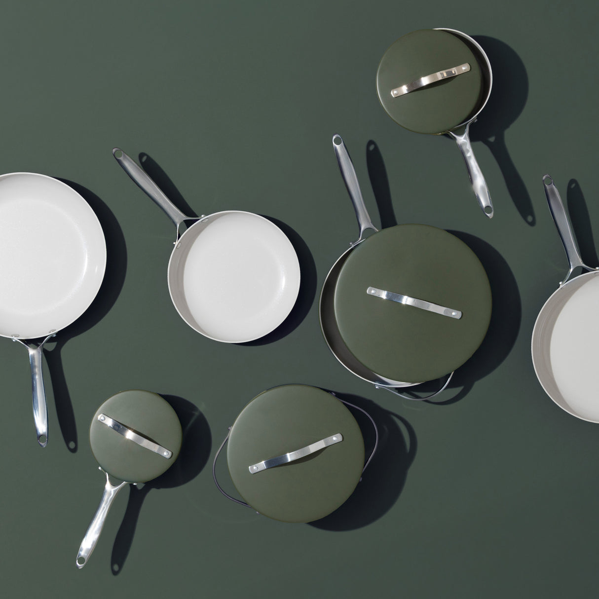Overhead view of ProChef green ceramic-coated aluminium cookware set with frying pans and saucepans on matching green background.