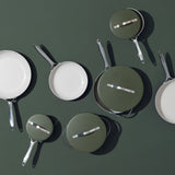 Overhead view of ProChef green ceramic-coated aluminium cookware set with frying pans and saucepans on matching green background.