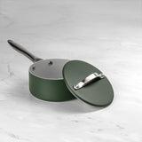 Green saucepan with lid on a white marble surface