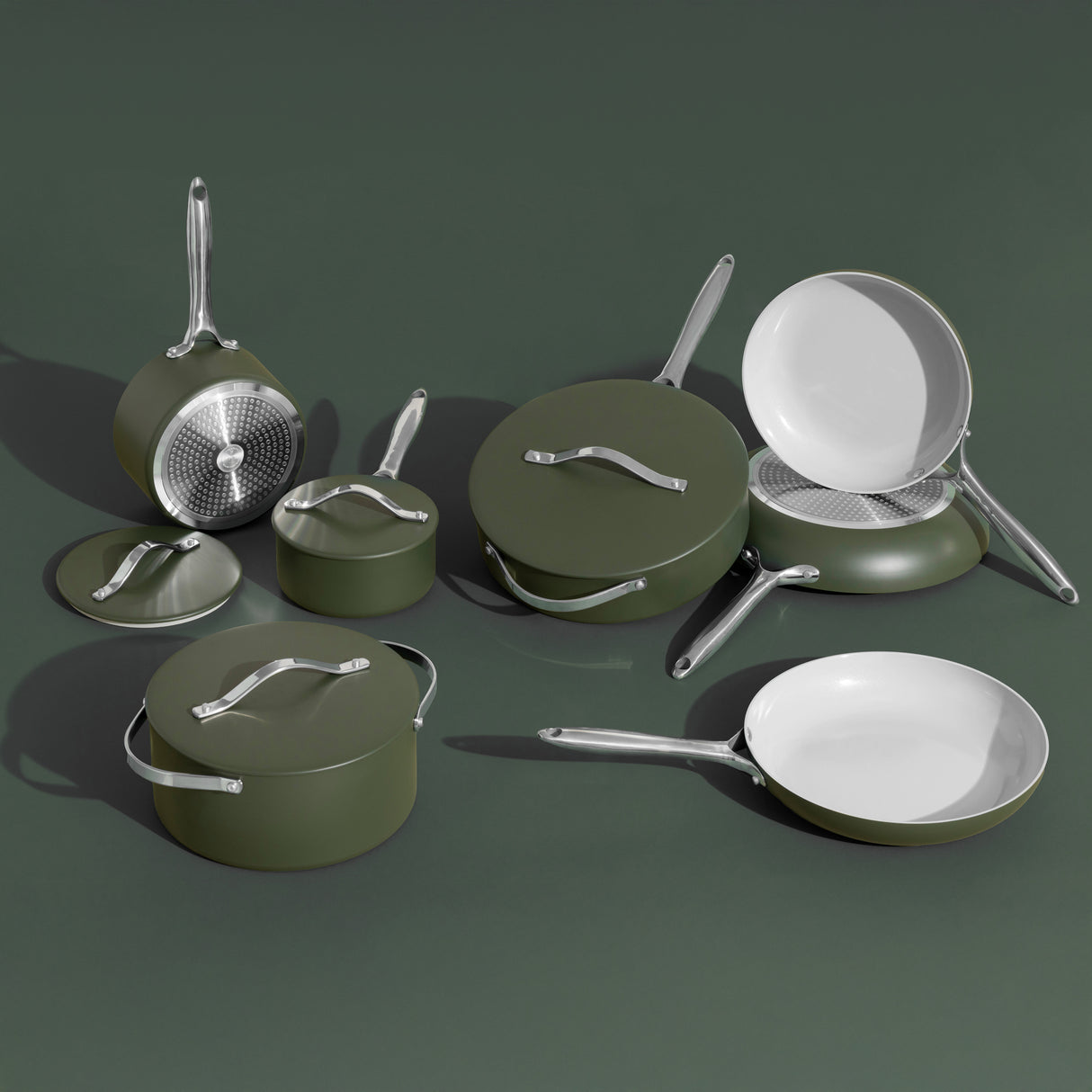 Set of green cookware including pots, pans, and lids on a dark green background