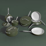 Set of green cookware including pots, pans, and lids on a dark green background