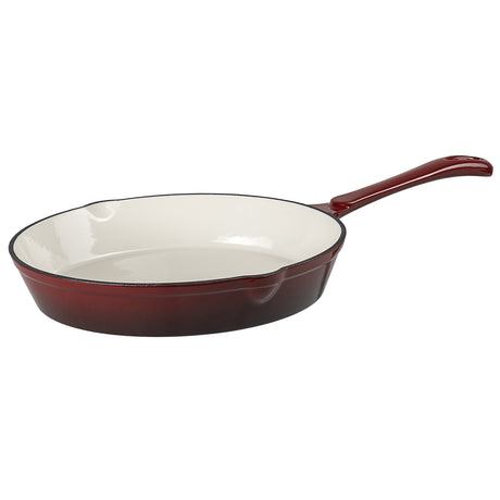 Red enameled cast iron skillet on a white background
