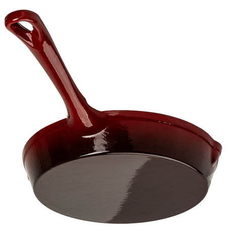 Red cast iron skillet underside on a white background