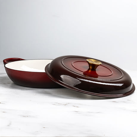 ProChef shallow cast iron casserole in rich red with white enamel interior, paired with matching lid featuring a gold knob.