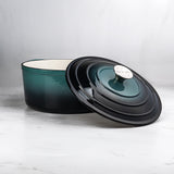 ProChef round cast iron casserole dish in deep teal with matching lid, enamel interior, perfect for slow cooking and roasting.