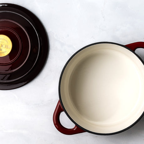 ProChef deep garnet enameled cast iron pot with white interior on a white surface