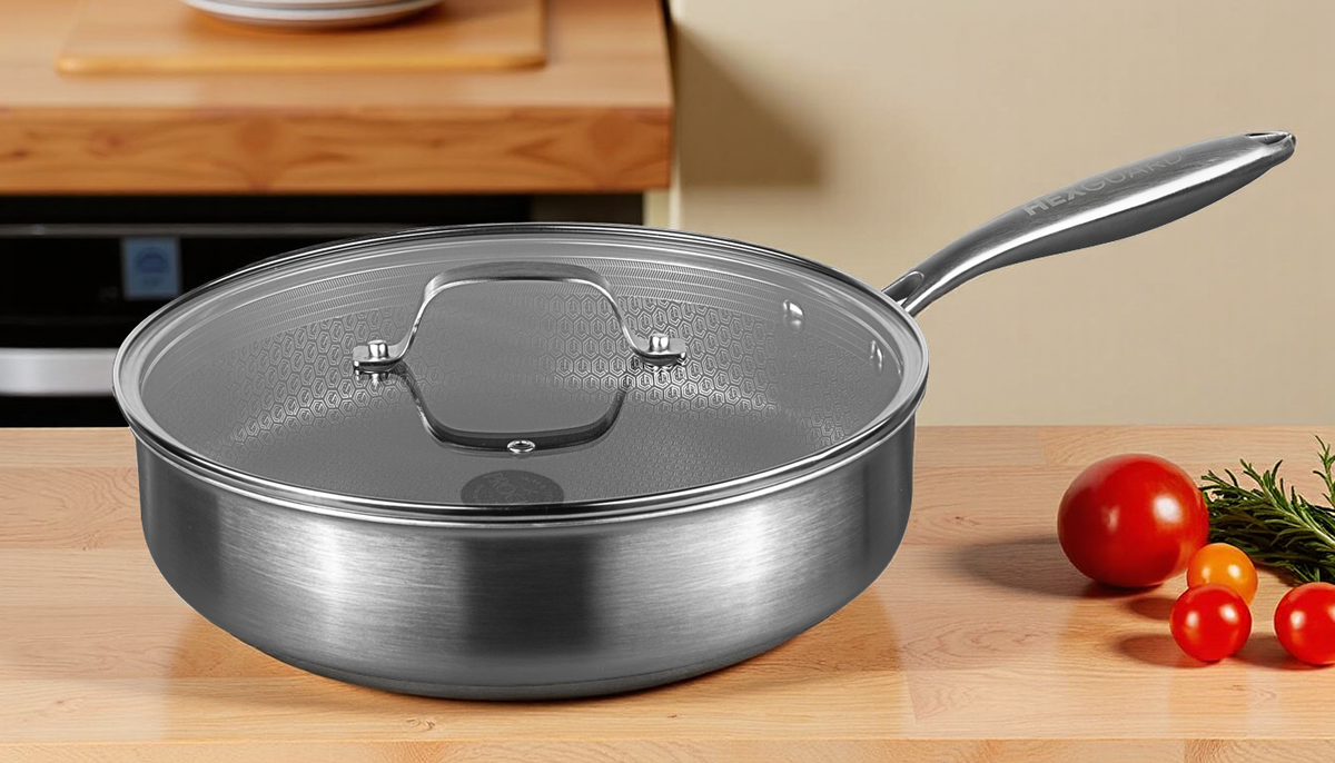 Silver HexGuard saute pan with lid on a wooden surface with vegetables