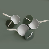 Top view of three ProChef green ceramic-coated aluminium saucepans with matching green lids and stainless steel handles, arranged on a muted green background.