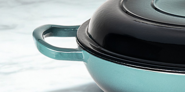 ProChef teal cast iron skillet with lid on a light background