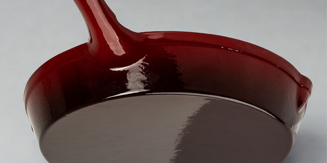 Close-up of a ProChef red cast iron skillet on a white background