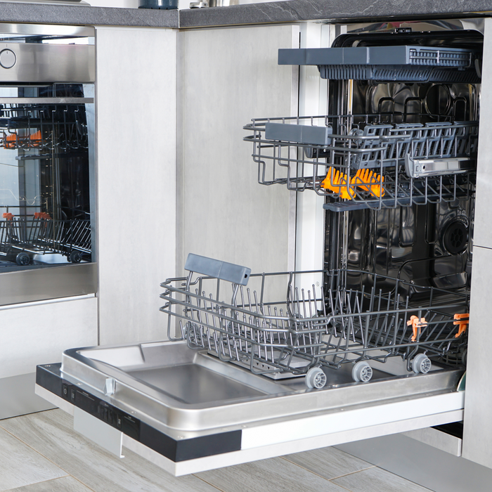Open dishwasher with racks and dishes inside, showing a modern kitchen setting.