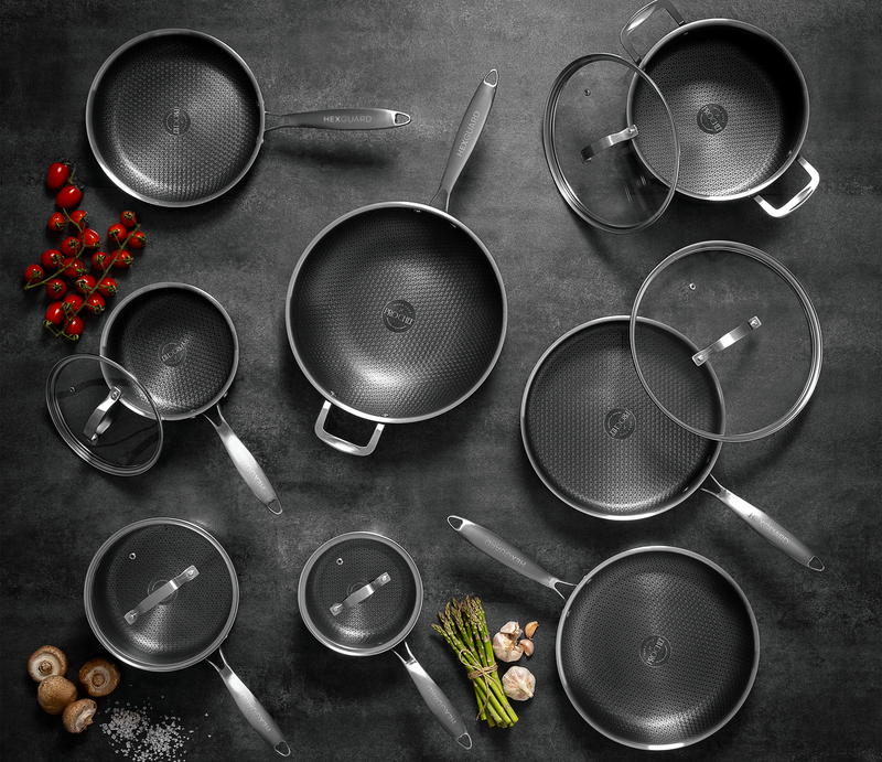 Top down shot of silver HexGuard cookware with lids on a dark surface