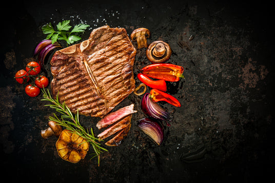 Steak with vegetables on a dark surface